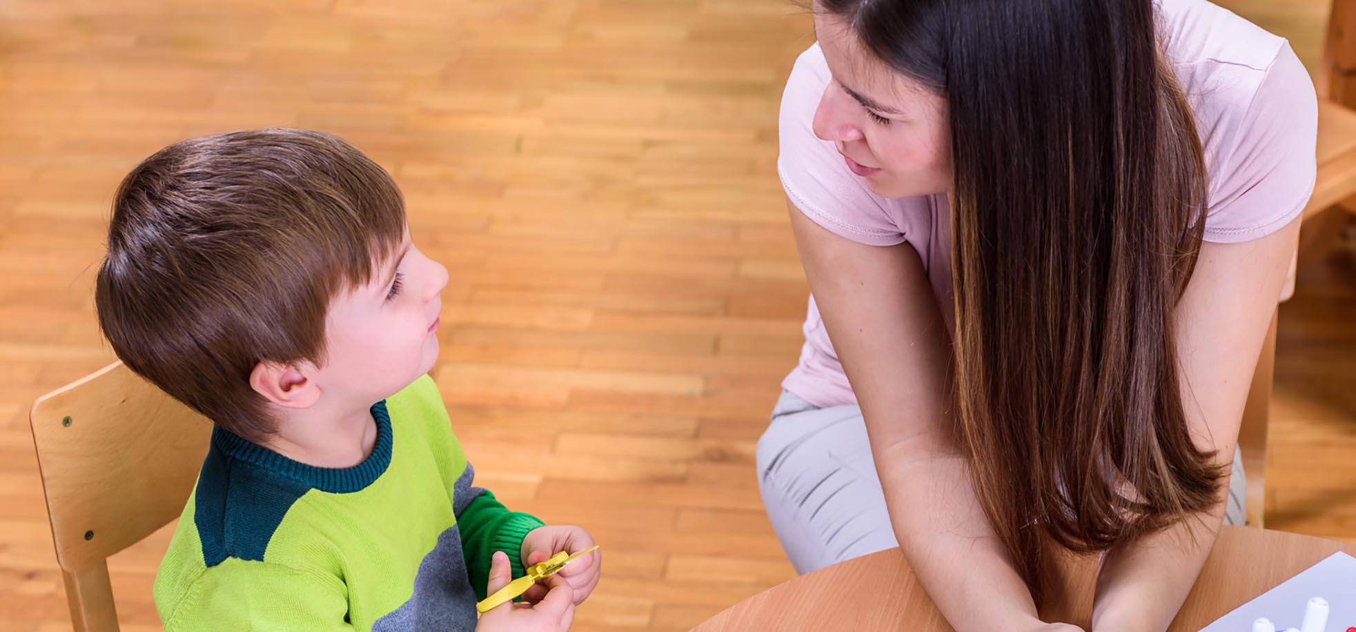 Teacher and cute boy Looking at Each Other - Supporting Child